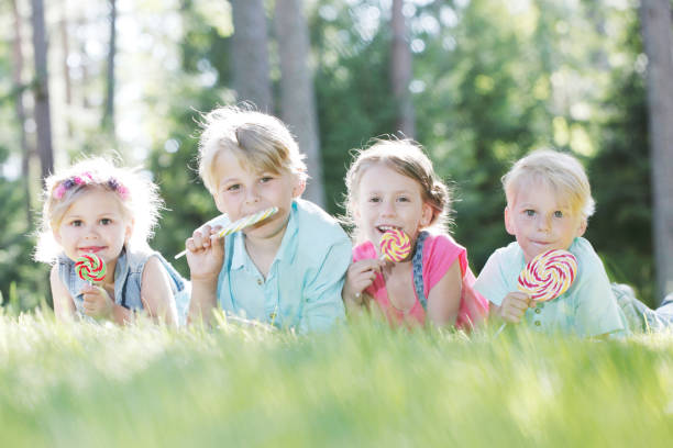 istock Happy children with lollipops 930793756