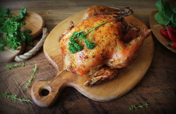 istock Whole roasted chicken on cutting board. Top view 930805276