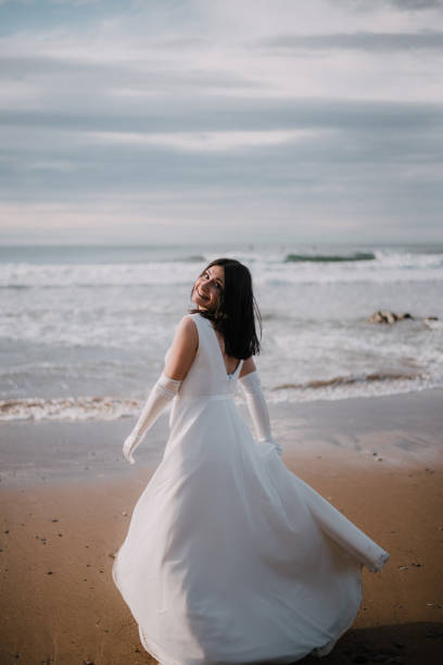 istock Woman in wedding dress at beach 930809340