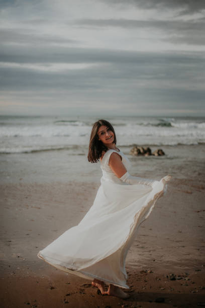istock Woman in wedding dress at beach 930809552
