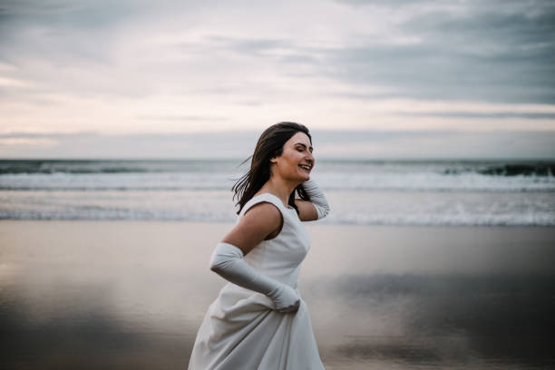 istock Woman in wedding dress at beach 930817030