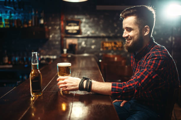 istock One bearded man drinks beer at the bar counter 930821202