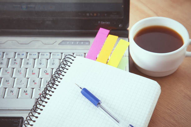 istock office working desk top view with laptop, notepad and coffee 930825204