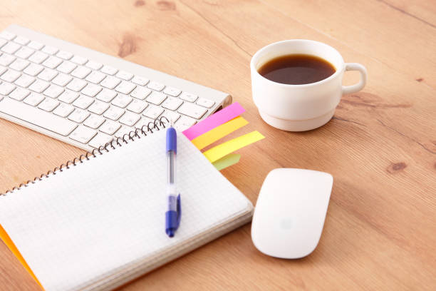 istock office working desk top view with laptop, notepad and coffee 930827296