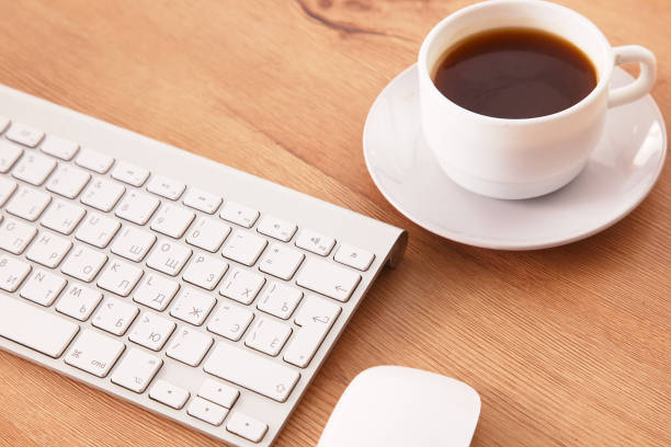 istock office working desk top view with laptop, notepad and coffee 930827318