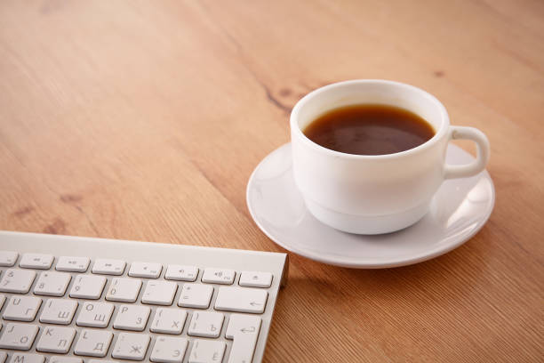 istock office working desk top view with laptop, notepad and coffee 930827394