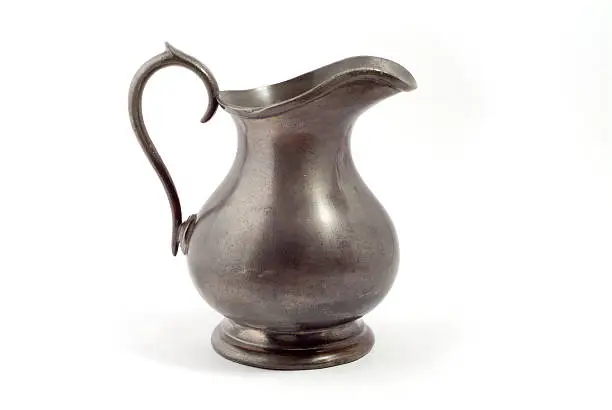 A small pewter jug isolated on white with a clipping path.