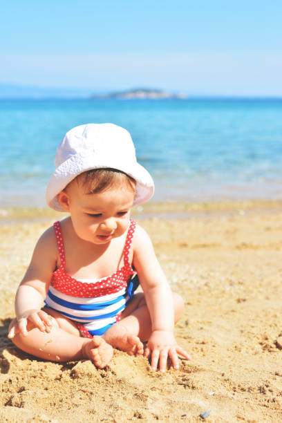 istock Cute baby girl on the beach 930835610