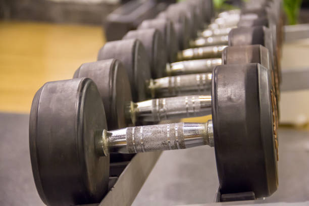 istock dumbbells on steel rack in weight training centre 930835650