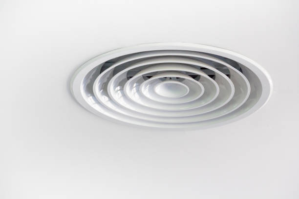 Circular air ventilation grill on the white ceiling