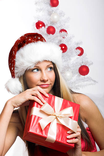 smiling christmas woman with a gift stock photo