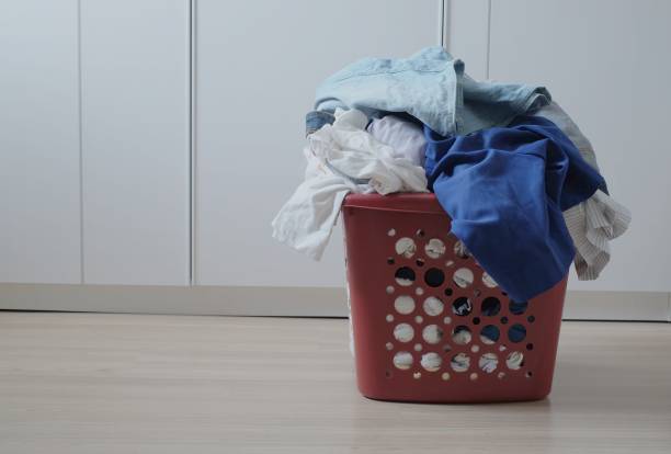 istock dirty clothes in red basket for washing 930844968