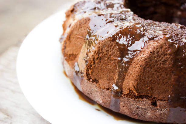 istock Homemade chocolate cake with chocolate syrup topping on white plate. Ring cake. 930848950