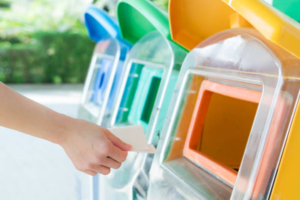 istock women hand throwing away the garbage to the bin/trash, sorting waste/garbage before drop to the bin 930851440