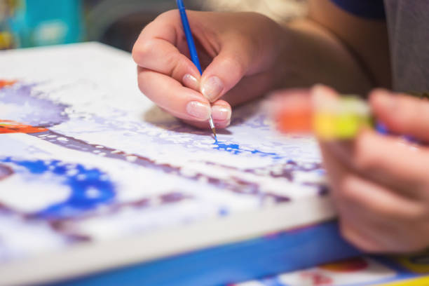 istock Woman is drawing the paint by numbers 930851626