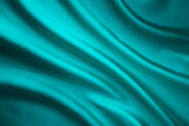 fabric waving silk background, teal satin cloth, wave shape - green silk textile shiny imagens e fotografias de stock