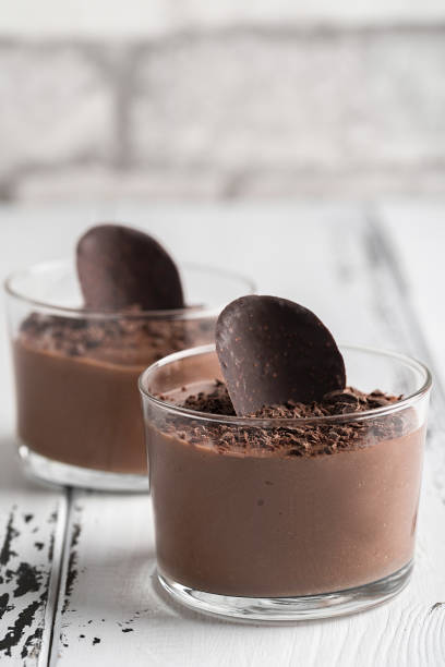 istock Chocolate mousse in a glasses on a white wood background. 930858738