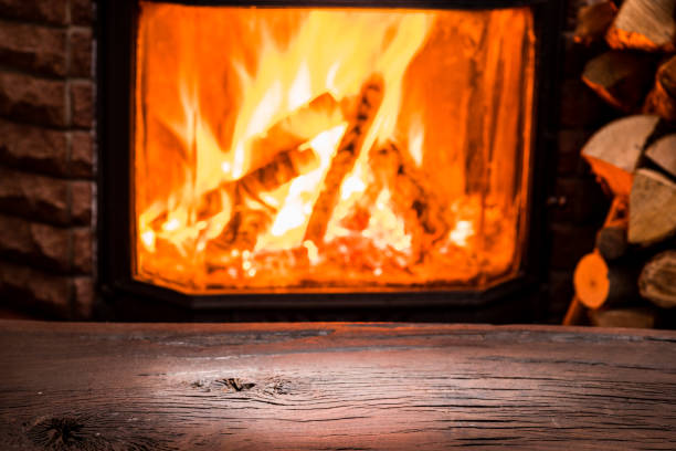 istock Wooden table top and burning warm fire. 930858790