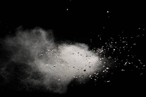 Small granite rock stone fly isolated on black background. Stone with white powder splash on dark background. Small granite rock stone fly isolated on black background. Stone with white powder splash on dark background. rubbish stock pictures, royalty-free photos & images