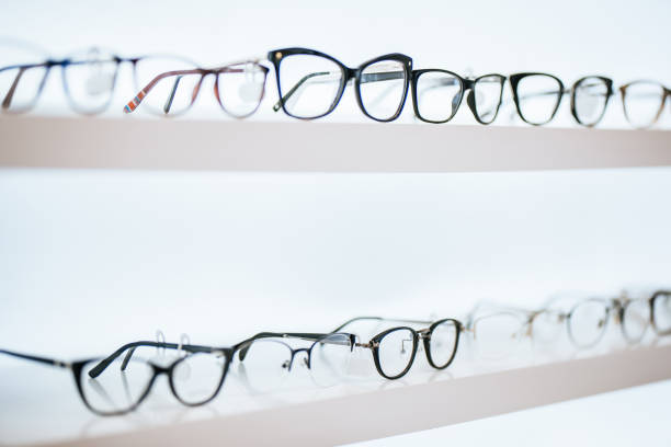 Big choice of eyeglasses on shelves in ophthalmology clinic. Modern light ophthalmology clinic.