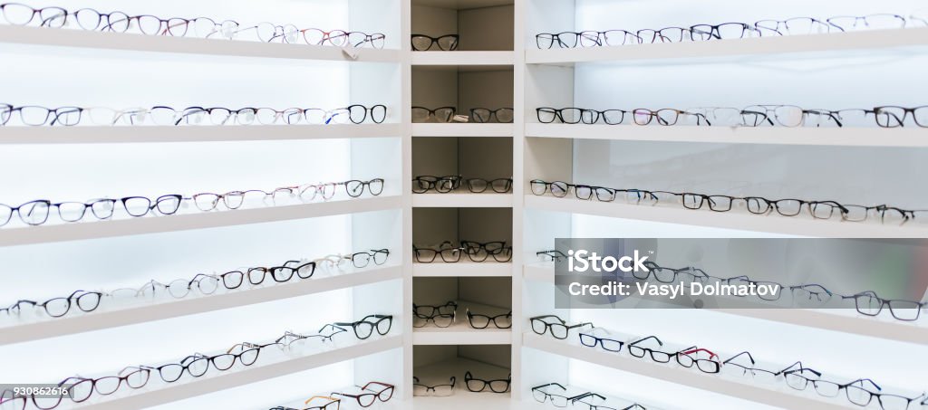 Eye glasses in ophthalmology clinic Big choice of eyeglasses on shelves in ophthalmology clinic. Modern light ophthalmology clinic. Store Stock Photo