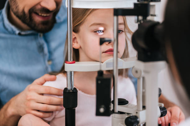 istock Dad with daughter in ophthalmology clinic 930864276