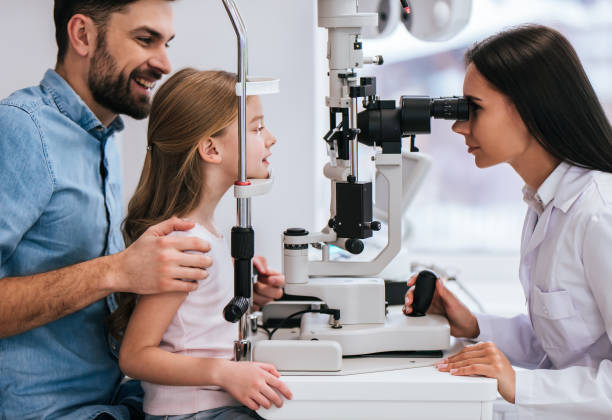 istock Dad with daughter in ophthalmology clinic 930864302