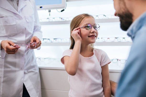istock Dad with daughter in ophthalmology clinic 930864346