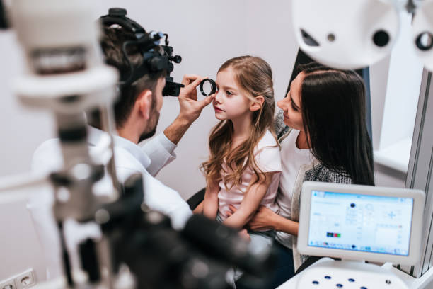 istock Mom with daughter in ophthalmology clinic 930864486