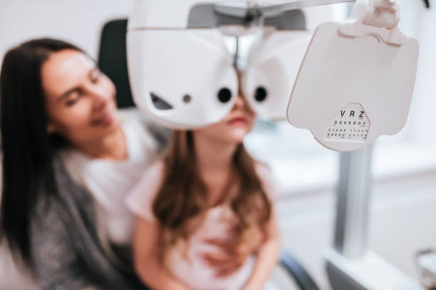istock Mom with daughter in ophthalmology clinic 930864494