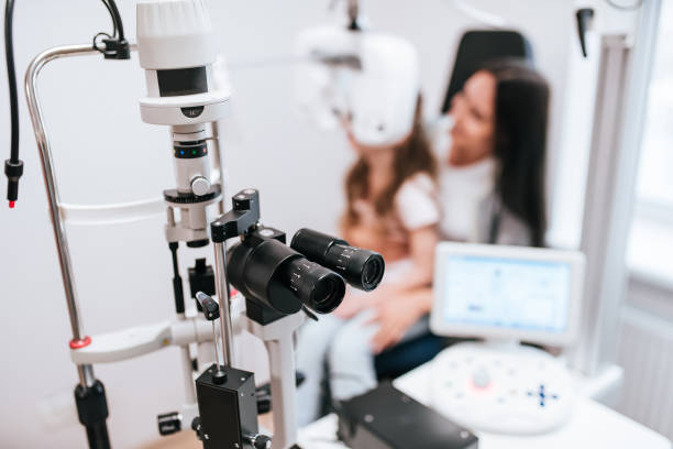 istock Mom with daughter in ophthalmology clinic 930864504
