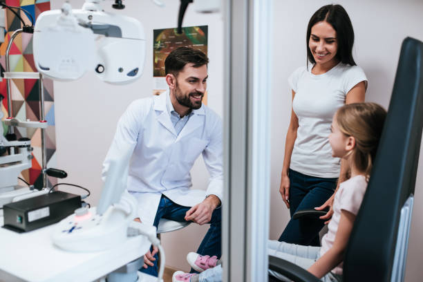istock Mom with daughter in ophthalmology clinic 930864546