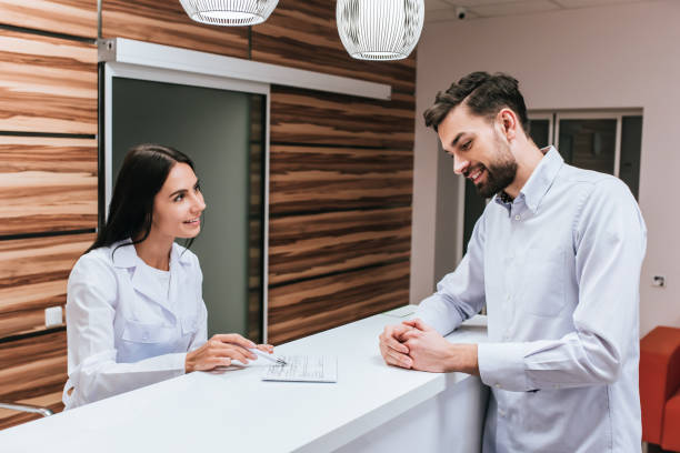 doctors in ophthalmology clinic - doctor patient greeting talking imagens e fotografias de stock