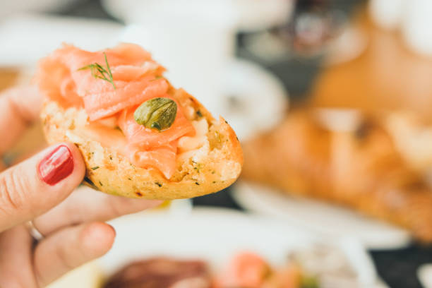 Woman hand with a salmon sandwich