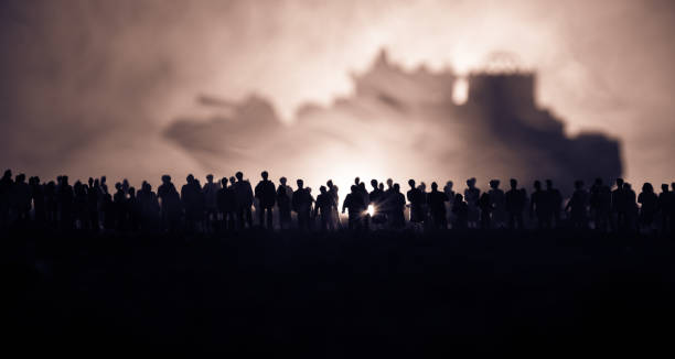 Silhouettes of a crowd standing at blurred military war ship on foggy background. Selective focus. Passengers try to escape. Silhouettes of a crowd standing at blurred military war ship on foggy background. Selective focus. Passengers try to escape. Protest of people dhow photos stock pictures, royalty-free photos & images