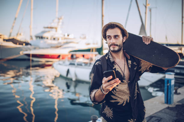 istock Man with skate walking in marina 930872430