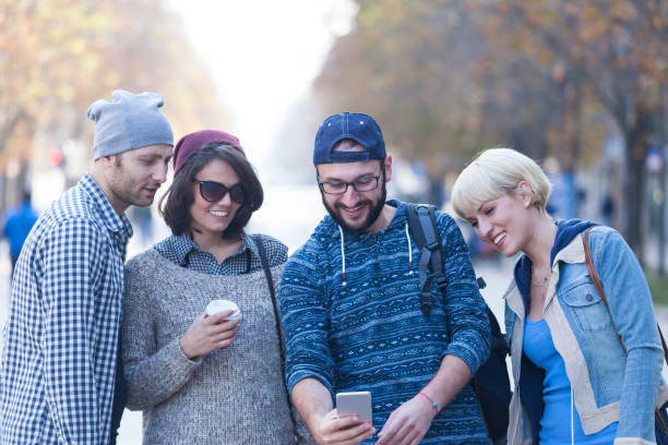 istock Tourists walking on street and taking selfie 930876112