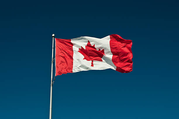 istock Big Canadian Flag against a Blue Sky 93087688
