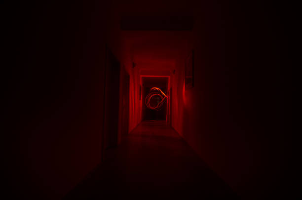 istock Dark corridor with cabinet doors and freezelight figures on it. Horror Concept. Halloween theme 930879328