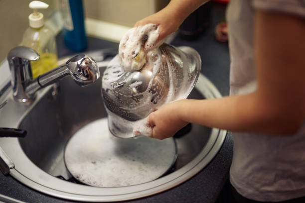istock Man is washing the dishes in the kitchen 930879552