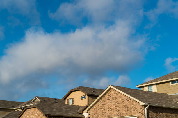 istock Suburban Brick Homes with clouds moving over head 930881878