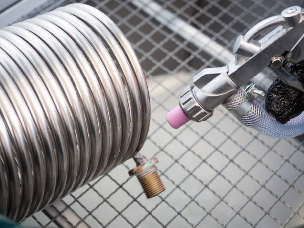 istock Sandblasting of a heat exchanger inside a special cabin. 930884362