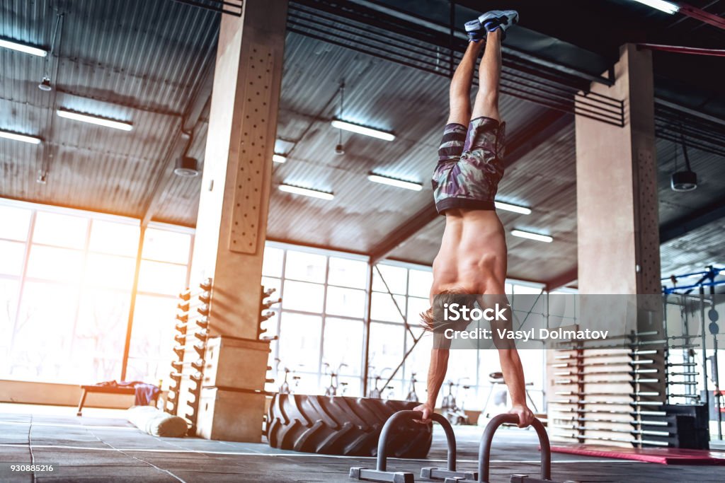 Strong man in gym Strong muscular man is working out in gym. gym training. Exercising Stock Photo