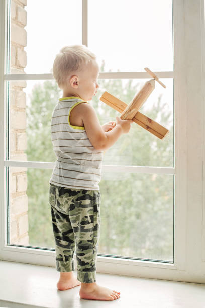 istock Little boy playing with wooden toy 930890250