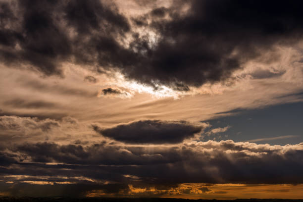 Dreamy cloudscape at sunset with streaks of lights from the sun