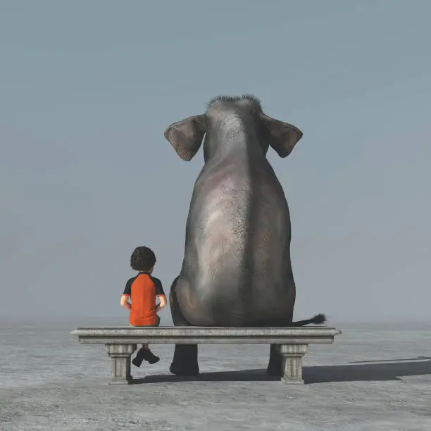 Photo of Little boy and an elephant sits on a bank and look to the horizon together