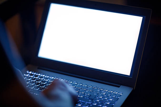 man's hands working on the laptop at late night