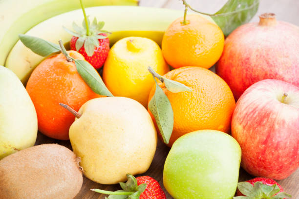 istock Multicolored Fruits On Wooden Background 930896368