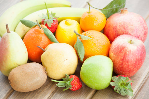 istock Multicolored Fruits On Wooden Background 930896532