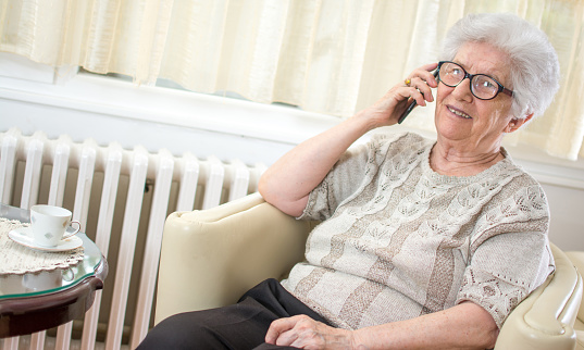 Smiling senior woman talking on mobile phone.